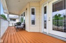 Expansive exterior deck featuring durable wood-finish flooring, white railing, and a textured ceiling with recessed lighting - 1727 Jubilee Loop, Sherwood Park, AB  - Outdoor With Deck Patio Veranda With Exterior 