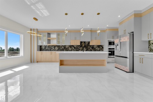 Contemporary kitchen featuring a large central island, stainless steel appliances, a dark stone backsplash, light wood-finish cabinetry, and polished tile flooring - 2027 156 Avenue, Edmonton, AB - Indoor Photo Showing Kitchen With Upgraded Kitchen