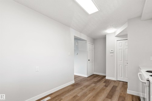 Interior space featuring wood-finish flooring, white walls, and bright overhead lighting - 707 Clareview Road, Edmonton, AB - Indoor Photo Showing Other Room