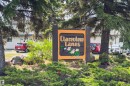 Prominent wooden community signage featuring a decorative floral motif - 707 Clareview Road, Edmonton, AB  - Outdoor 