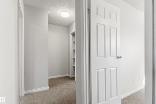 Hallway featuring light gray wall paint, white trim, and neutral-toned carpet flooring - 707 Clareview Road, Edmonton, AB - Indoor Photo Showing Other Room