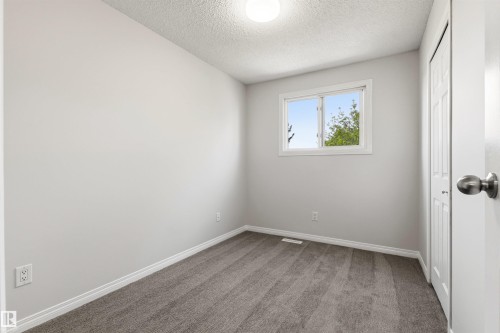 Room featuring neutral grey carpet, white baseboards, and light grey walls - 707 Clareview Road, Edmonton, AB - Indoor Photo Showing Other Room