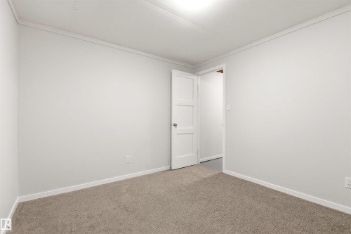 Light gray wall finishes with white trim and crown molding - 707 Clareview Road, Edmonton, AB - Indoor Photo Showing Other Room