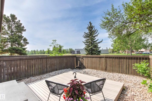 Expansive outdoor deck with composite decking, surrounded by a privacy fence and decorative gravel - 707 Clareview Road, Edmonton, AB - Outdoor With Deck Patio Veranda