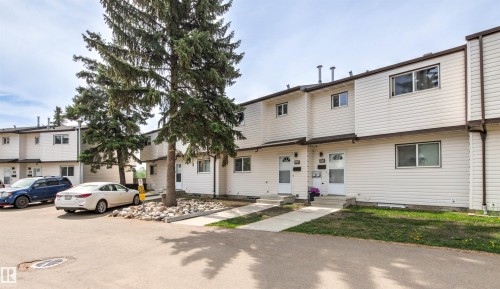 Townhouse exterior featuring light-colored horizontal siding and brown trim - 707 Clareview Road, Edmonton, AB - Outdoor With Facade