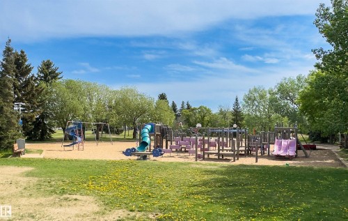 Outdoor recreational area featuring multiple play structures, sand base, and mature perimeter trees - 707 Clareview Road, Edmonton, AB - Outdoor With View