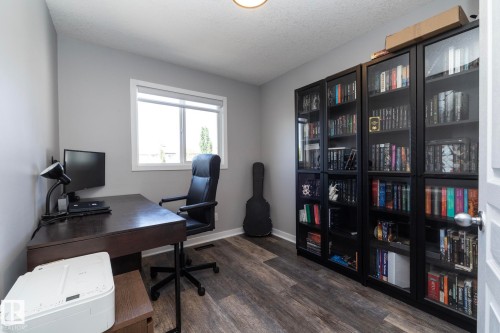 Room with light gray walls, wood-finish flooring, and a single window with white trim - 4204 161 Avenue, Edmonton, AB - Indoor Photo Showing Office