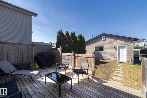 Spacious backyard featuring a wooden deck, privacy fencing, and a stone pathway - 4204 161 Avenue, Edmonton, AB - Outdoor With Deck Patio Veranda With Exterior