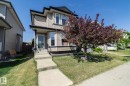Two-story residence featuring light-colored siding, a dark trim roofline, and a covered front entry - 4204 161 Avenue, Edmonton, AB  - Outdoor 