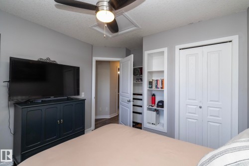 Neutral gray walls complement the white trim and bi-fold closet doors - 4204 161 Avenue, Edmonton, AB - Indoor Photo Showing Bedroom
