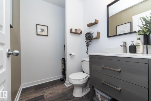 Contemporary vanity featuring a white countertop, undermount sink, and brushed nickel faucet - 4204 161 Avenue, Edmonton, AB - Indoor Photo Showing Bathroom