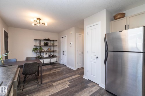 Dining area featuring durable wood-finish flooring and a contemporary multi-bulb ceiling light fixture - 4204 161 Avenue, Edmonton, AB - Indoor