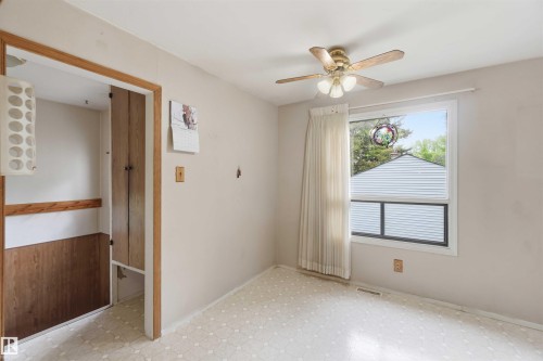Bright room featuring a ceiling fan, a window with natural light, and patterned vinyl flooring - 16 Michigan Street, Devon, AB - Indoor Photo Showing Other Room