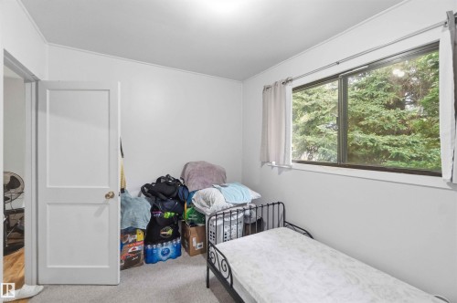 Room featuring light gray carpet, white walls, and a large window with white trim - 16 Michigan Street, Devon, AB - Indoor Photo Showing Other Room
