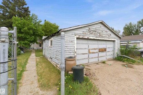 Detached garage structure with a single bay door and an adjacent walkway leading to the main residence - 16 Michigan Street, Devon, AB - Outdoor