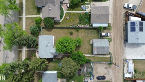 Aerial view showcasing a residential property with a shingled roof and a generous backyard space - 16 Michigan Street, Devon, AB - Outdoor