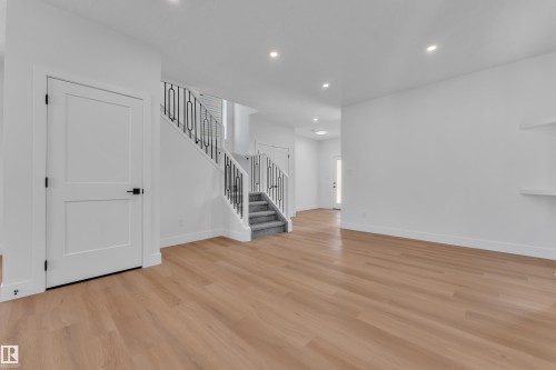 Open living area featuring wood-finish flooring, recessed lighting, and white walls - 6092 179 Ave Nw, Edmonton, AB - Indoor Photo Showing Other Room