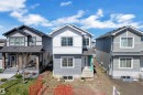 Newly constructed residence featuring a gray and white exterior with horizontal siding and vertical paneling - 6092 179 Ave Nw, Edmonton, AB  - Outdoor With Facade 