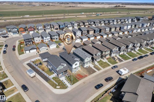 Contemporary two-story residence with a dark-pitched roof and light-colored siding - 6092 179 Ave Nw, Edmonton, AB - Other