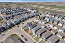 Contemporary residential neighborhood featuring a variety of single-family homes with asphalt shingle roofs - 6092 179 Ave Nw, Edmonton, AB  - Outdoor With View 
