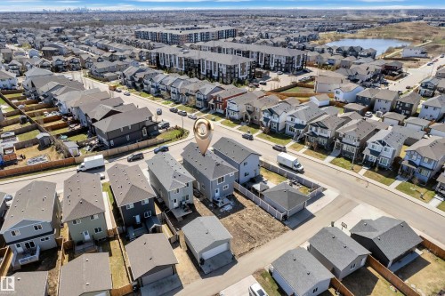Residential property featuring a light grey exterior with a dark grey roof - 6092 179 Ave Nw, Edmonton, AB - Outdoor With View