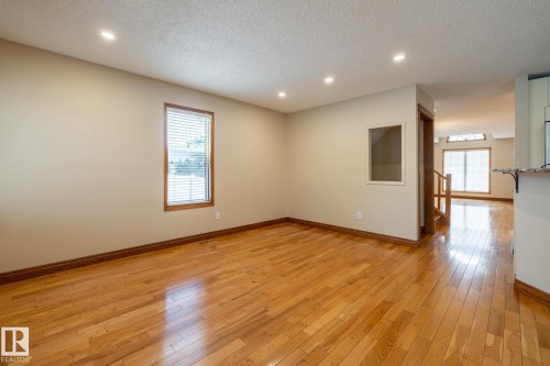 Spacious interior featuring wood-finish flooring, recessed lighting, and neutral wall tones - 4632 151 Street, Edmonton, AB - Indoor Photo Showing Other Room
