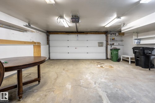 Single-bay garage with a concrete floor, overhead lighting, and white walls - 4632 151 Street, Edmonton, AB - Indoor Photo Showing Garage