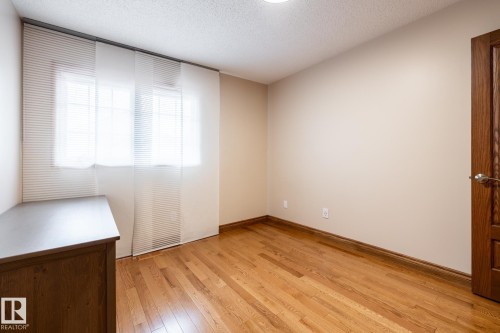 Bright interior space featuring wood-finish flooring and neutral wall tones - 4632 151 Street, Edmonton, AB - Indoor Photo Showing Other Room