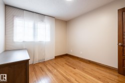 Bright interior space featuring wood-finish flooring and neutral wall tones - 