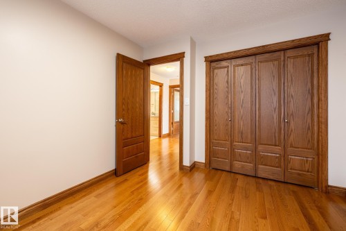 Hardwood flooring extending throughout the room and into the hallway - 4632 151 Street, Edmonton, AB - Indoor Photo Showing Other Room