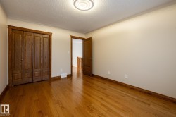 Hardwood flooring extending throughout, bi-fold closet doors, and wood-finish trim - 