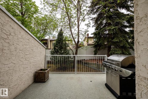 Private outdoor patio space featuring a textured stucco wall and speckled concrete flooring - 4632 151 Street, Edmonton, AB - Outdoor