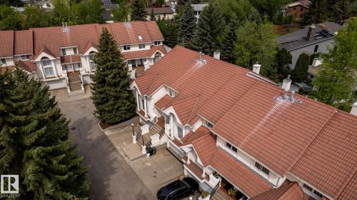 Townhome complex with terracotta tile roofing and white stucco exteriors - 4632 151 Street, Edmonton, AB - Outdoor