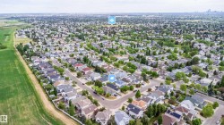 Residential neighborhood featuring a mix of architectural styles, mature trees, and paved streets - 