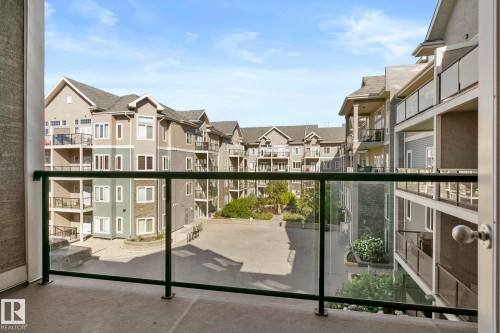 Private balcony with a glass railing system overlooking an inner courtyard - 334 10121 80 Avenue, Edmonton, AB - Outdoor With Balcony