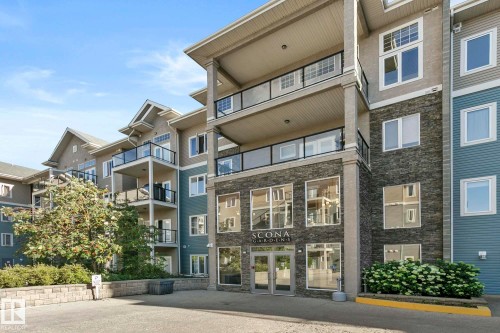 Multi-story residential building featuring a stone facade entrance and prominent balconies with glass railings - 334 10121 80 Avenue, Edmonton, AB - Outdoor With Balcony With Facade