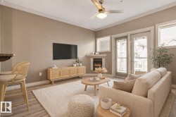 Living space featuring wood-finish flooring, a ceiling fan with integrated lighting, and crown molding - 