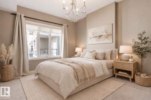 Bedroom featuring a three-panel window with neutral drapery, upholstered bed frame, and recessed lighting - 334 10121 80 Avenue, Edmonton, AB - Indoor Photo Showing Bedroom