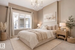 Bedroom featuring a three-panel window with neutral drapery, upholstered bed frame, and recessed lighting - 