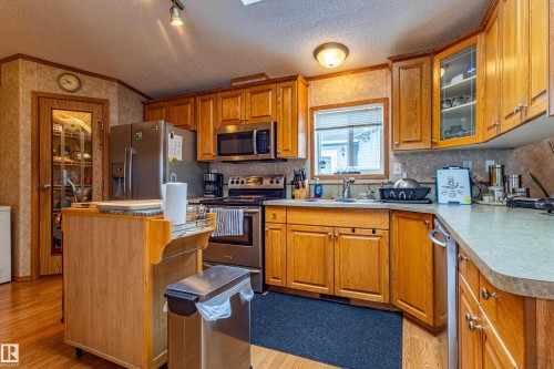 Kitchen featuring wood-finish cabinetry, stainless steel appliances, and a built-in oven with stovetop - 1529 Range Road 272 Rural Parkland County, Alberta, Rural Parkland County, AB - Indoor Photo Showing Kitchen