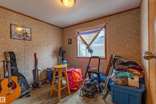 Interior room featuring a single window with wood trim, textured panel walls with wood accents, and ceiling light fixture - 1529 Range Road 272 Rural Parkland County, Alberta, Rural Parkland County, AB - Indoor Photo Showing Other Room