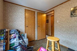 Interior space featuring textured wall finishes and wood-grain doors - 