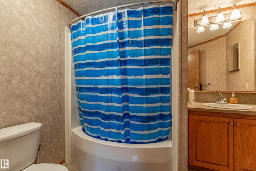 Bathroom featuring a shower/tub combination, wall-mounted vanity with a single basin sink, and a mirrored medicine cabinet - 1529 Range Road 272 Rural Parkland County, Alberta, Rural Parkland County, AB - Indoor Photo Showing Bathroom