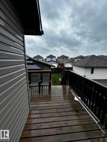 Wood-finish deck with dark railings - 1868 30 Street Nw, Edmonton, AB - Outdoor With Exterior