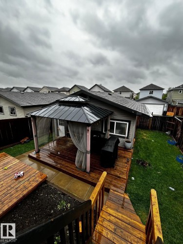 Expansive multi-level wood deck featuring a covered gazebo with mosquito netting - 1868 30 Street Nw, Edmonton, AB - Outdoor With Deck Patio Veranda