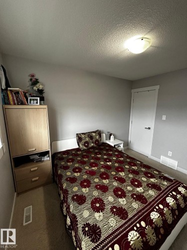 Bedroom featuring neutral gray walls, carpeting, and a flush-mount ceiling light fixture - 1868 30 Street Nw, Edmonton, AB - Indoor Photo Showing Bedroom