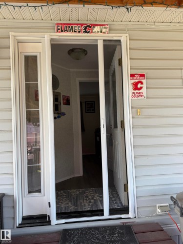White frame entry door with sidelight and integrated screen door - 5012 53 Ave, Breton, AB 