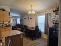 Open concept living area featuring vinyl plank flooring, - 5012 53 Ave, Breton, AB 