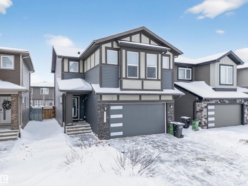 Contemporary residence featuring a multi-tone facade with horizontal siding and stone accents - 6085 King Landing, Edmonton, AB - Outdoor With Facade