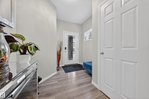 Entryway featuring wood-finish flooring, light grey walls, and white trim - 6085 King Landing, Edmonton, AB - Indoor Photo Showing Other Room